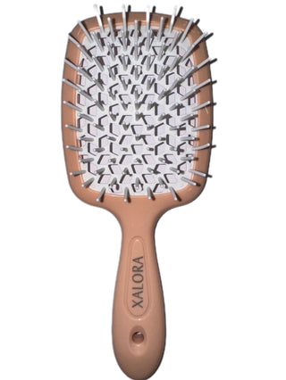 Hairbrush with a brown handle and white bristles on a white background